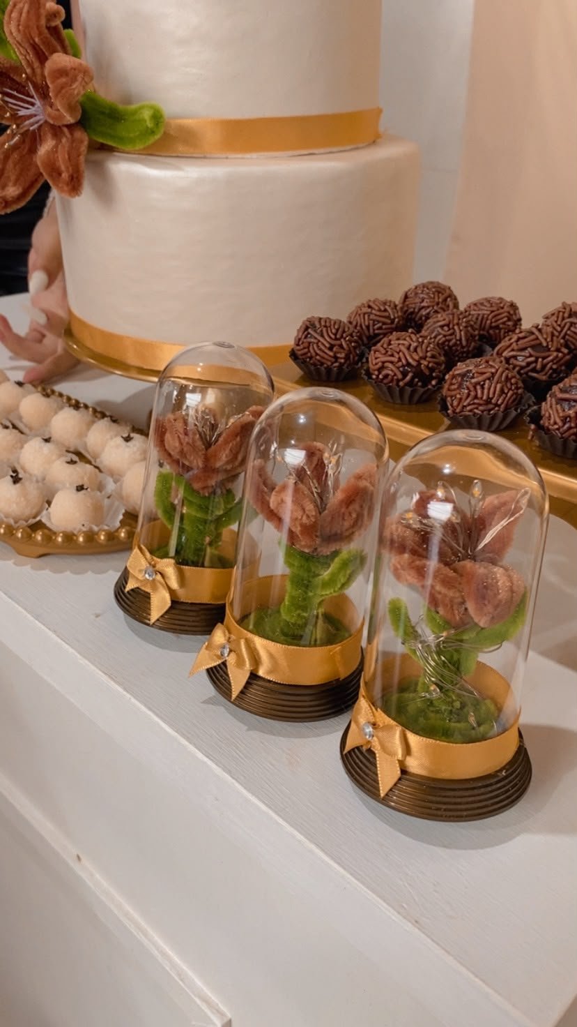 Lembrancinhas artesanais com flores decorativas em redomas transparentes